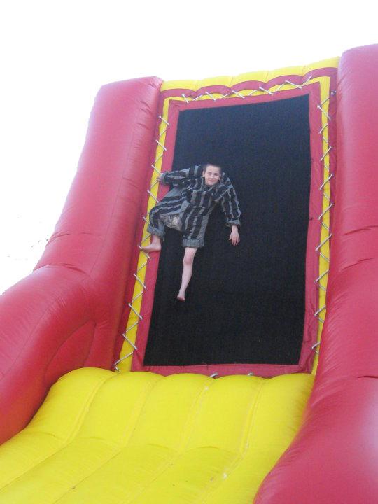 Little boy sticking to the Velcro Wall