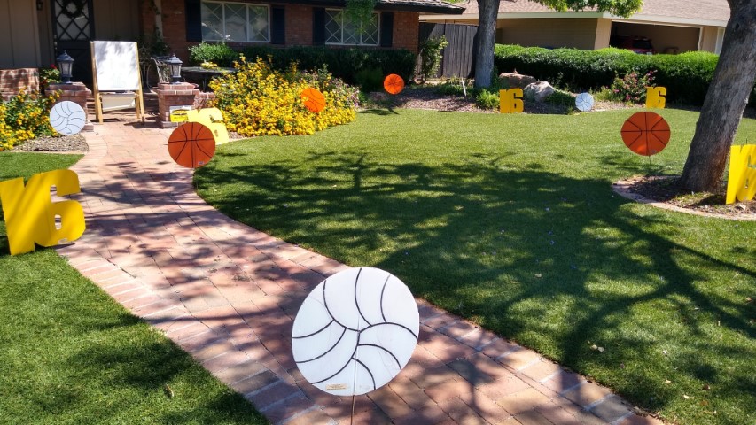 Happy birthday yard sign greeting with number 16s, basketballs and volleyballs in Moon Valley Arizona