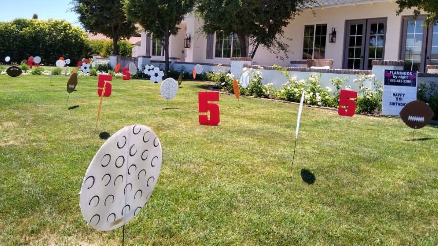 Birthday yard sign display of big number 5s, golf balls, footballs and soccer balls near Scottsdale AZ