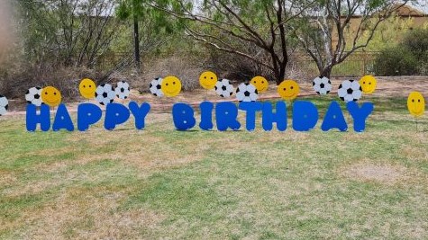 blue Happy Birthday letters with soccer balls and smileys yard card greeting in Carefree AZ