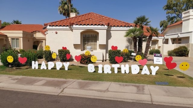 white Happy Birthday yard sign greeting with hearts and smileys near Buckeye Arizona