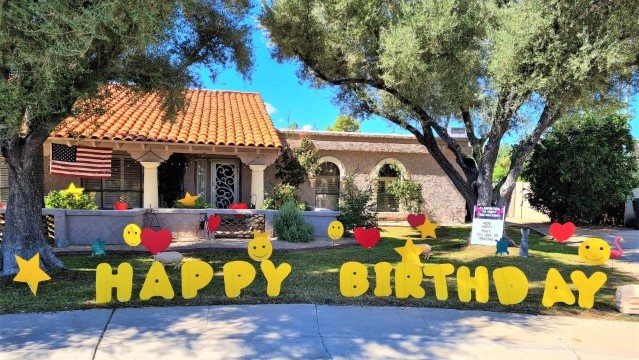 Scottsdale, AZ. Yellow Happy Birthday yard signs with smileys, hearts, 
