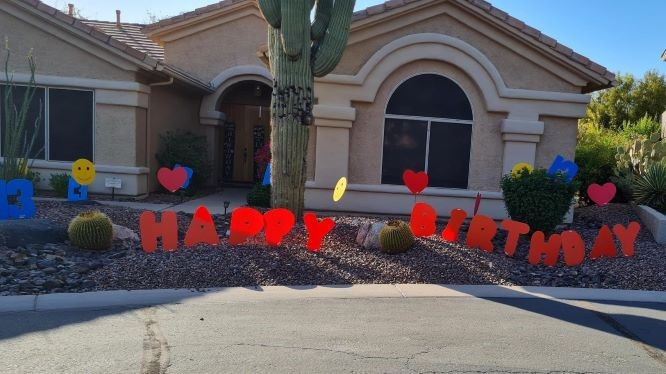 big orange Happy Birthday letters with number 13s & hearts birthday surprise. Near Ahwatukee