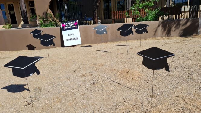 Yard card greeting display of graduation caps. Desert Hills AZ