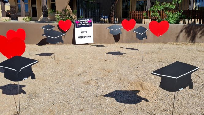 graduation yard sign display of caps & hearts near Scottsdale